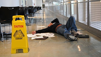 A man laying on the floor in an office building